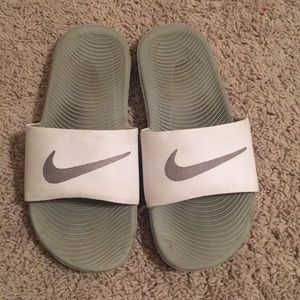 Grey and White Nike slides